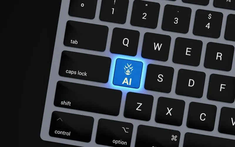 Laptop keyboard with a glowing blue AI key in place of the A key, representing AI built into everyday software work.